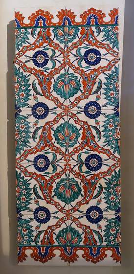 An Iznik tile panel of blue and red flowers